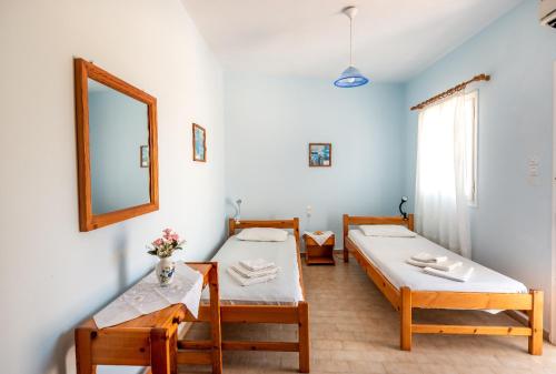 a room with two beds and a mirror at Giannis apartment in Kalymnos