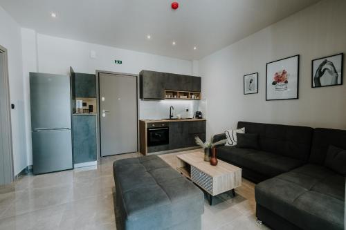 a living room with a couch and a table at Pearl Apartel in Volos