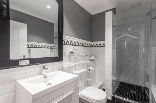 a bathroom with a sink and a toilet and a shower at Romney Park Luxury Apartments by The Stay Collection in Cape Town