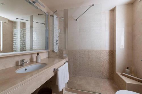 a bathroom with a sink and a mirror at Puerto Sotogrande con vistas al mar in Sotogrande