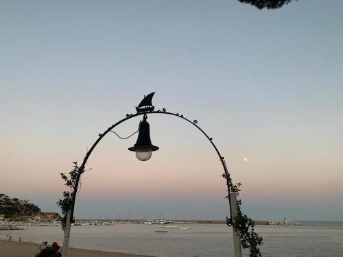 a street light with a bird sitting on top of it at La Casa M'SOL in Sant Feliu de Guixols