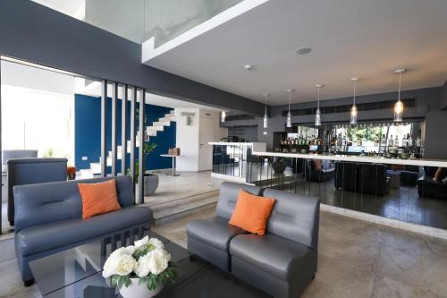 a living room with two couches and a bar at Aleph Boutique Hotel in Jbeil
