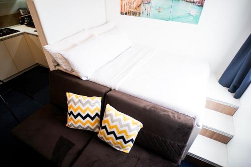 a bedroom with a bed and two pillows on the floor at Modern Designed Studio Condo Near Ayala Centrio in Cagayan de Oro