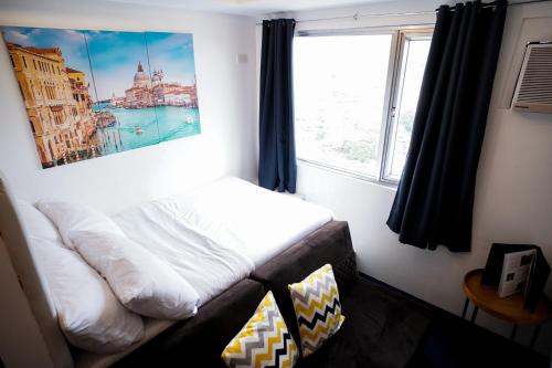 a bed in a room with a window at Modern Designed Studio Condo Near Ayala Centrio in Cagayan de Oro