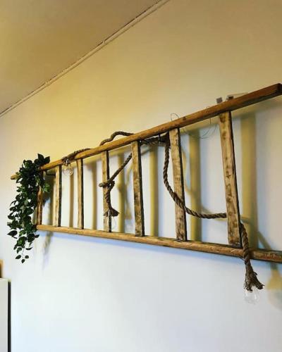 a wooden railing with a plant on top of it at Petit T2 proche centre et stade tribut Dunkerque in Dunkerque