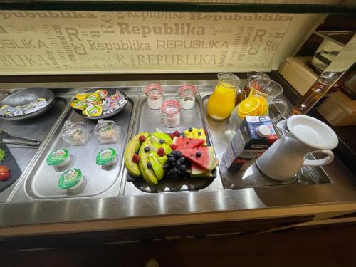 a tray with a plate of food on a table at Wellness Hotel Republika 24 Apartments in Plzeň