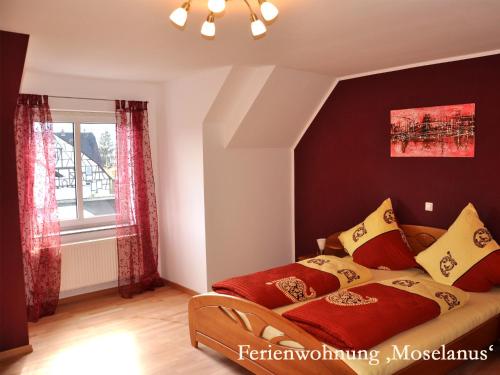 a bedroom with a bed and a window at Ferienwohnungen Ferienland Cochem in Bruttig-Fankel