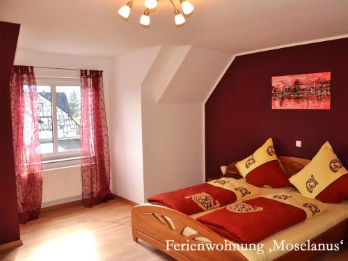 a bedroom with a bed and a window at Ferienwohnungen Ferienland Cochem in Bruttig-Fankel