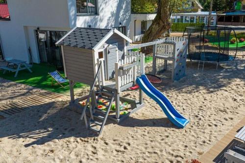 a playground with a slide at Cottage near the beach for 3 people in Pustkowo in Pustkowo