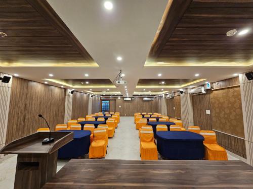 a lecture hall with rows of chairs and desks at Hotel Starway in Balasore