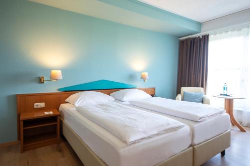 ACHAT Hotel Frankfurt Maintalにあるベッド