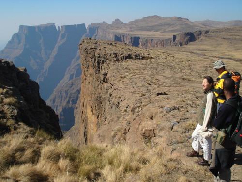 a group of people standing on the edge of a canyon at Three Tree Hill Lodge in Bergville