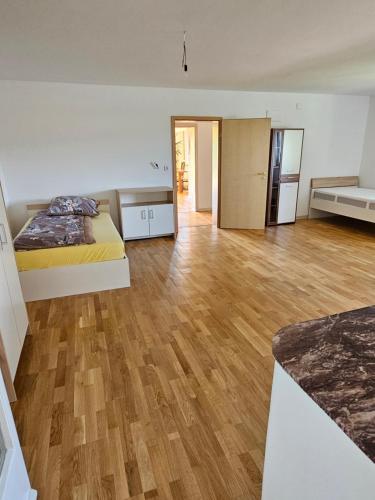 a large room with two beds and a wooden floor at ⌂ Privatwohnung in Burghaun