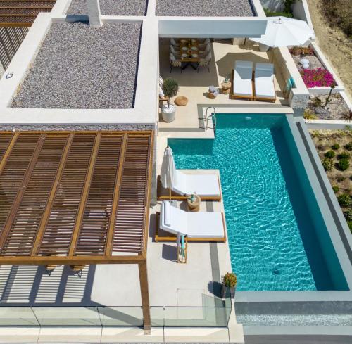 an aerial view of a house with a swimming pool at Sun n Salt Private Villas in Agios Georgios Pagon