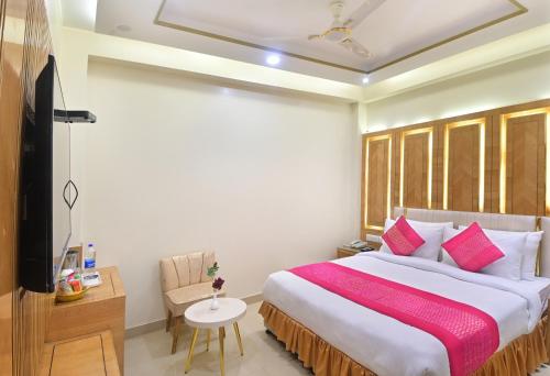 a bedroom with a large bed with a red blanket at Hotel Gold Palace - 03 Mins Walk From New Delhi Railway Station in New Delhi