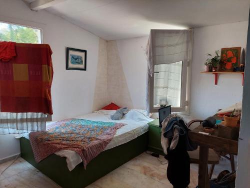 a small bedroom with a bed and a window at Zima Art Studio in Marmaris