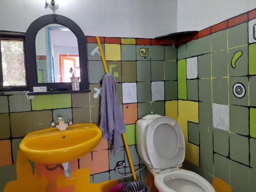 a bathroom with a yellow sink and a toilet at Zima Art Studio in Marmaris