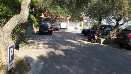 a street with cars parked on the side of the road at Rooms Vukušić in Rab