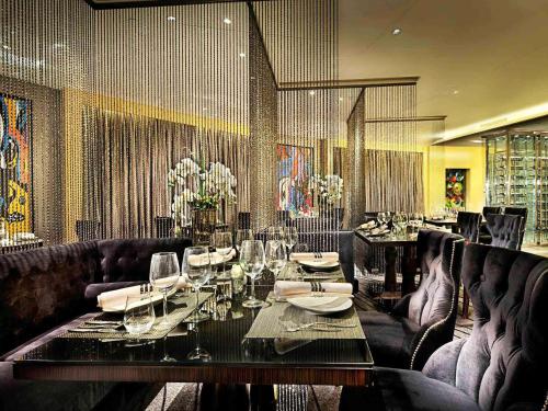 a dining room with a table with wine glasses at Enlux Hotel in Jinan