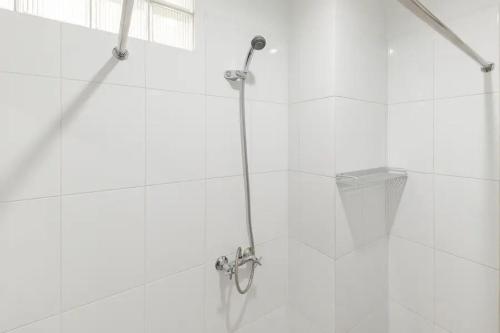 a shower with a glass door in a bathroom at KoolKost near BTC Fashion Mall 2 - Minimum Stay 30 Nights in Bandung