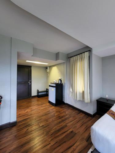 a room with a bed and a wooden floor at Hua Hin Home Hill in Hua Hin