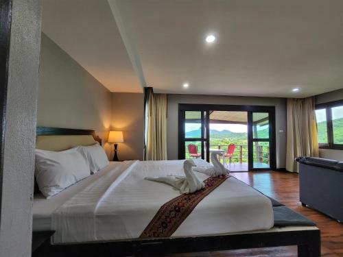 a bedroom with a bed with two birds on it at Hua Hin Home Hill in Hua Hin