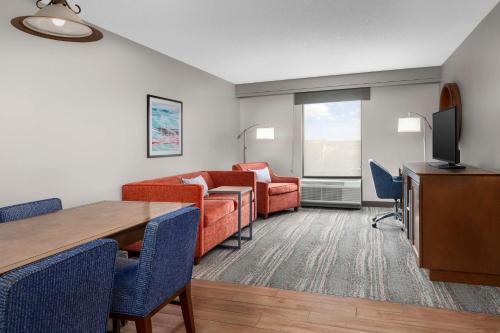 a living room with a couch and a table at Hampton Inn & Suites at Lake Mary Colonial Townpark in Lake Mary