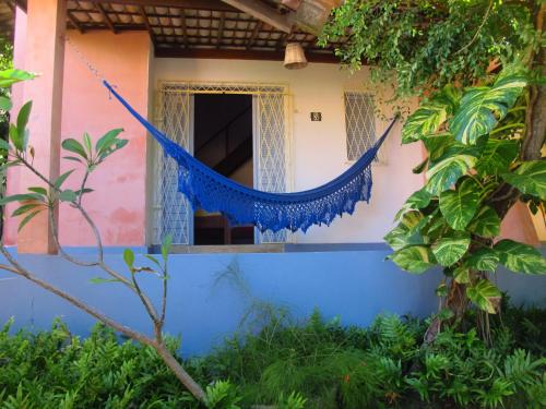 a house with a hammock outside of it at Stay Cool Pipa in Pipa