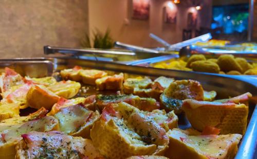 a buffet with a bunch of food on a table at Pousada Jovimar in Aparecida