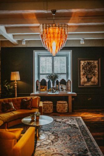 a living room with a couch and a chandelier at The Croft Hotel in Darlington