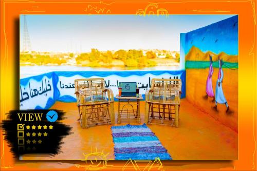a group of chairs and a table with a laptop at Opal privat nubian hotel in Aswan