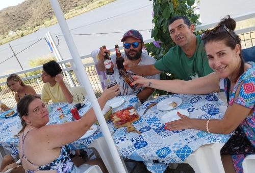 a group of people sitting around a table drinking beer at Paisagem do Guadiana Turismo Rural in Odeleite