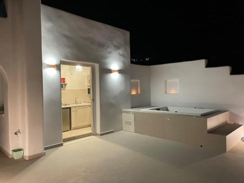 a large kitchen with a sink and a bathroom at thErοs - Sunset view apartment in Parikia