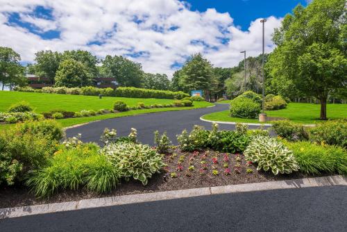 a garden with flowers and a winding road at Sonesta ES Suites Andover Boston in Andover