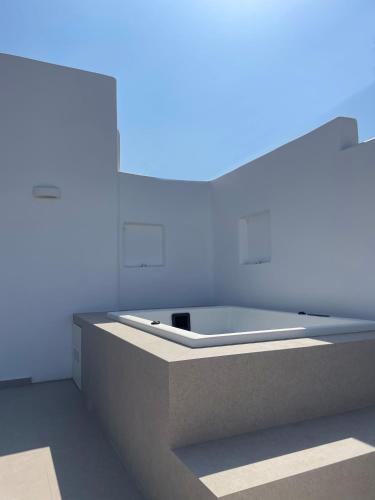 a bath tub in a room with blue lighting at thErοs - Sunset view apartment in Parikia
