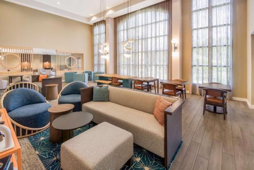 a living room with a couch and chairs and tables at Sonesta ES Suites Andover Boston in Andover