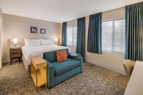 um quarto de hotel com uma cama e uma cadeira em Sonesta ES Suites Andover Boston em Andover