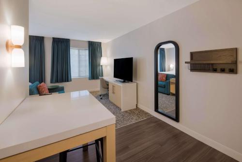 a hotel room with a vanity and a mirror at Sonesta ES Suites Andover Boston in Andover