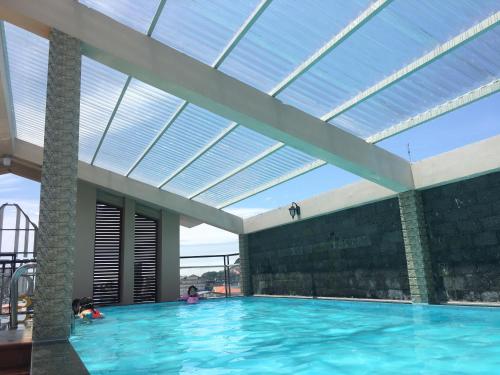 a swimming pool with a skylight in a building at Co Ba Vung Tau Hotel in Vung Tau