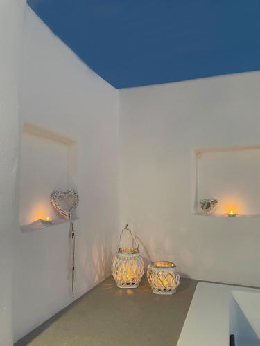 two vases sitting on a table in a room at thErοs - Sunset view apartment in Parikia
