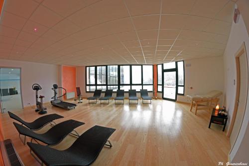 a large room with chairs and a gym at Villa Clorè Hotel & Spa in Lama Mocogno