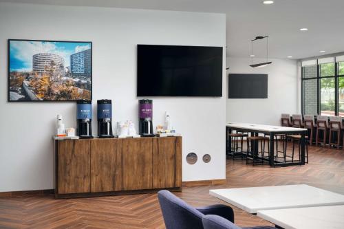 a room with a flat screen tv on a wall at Hampton Inn Towson Downtown in Towson