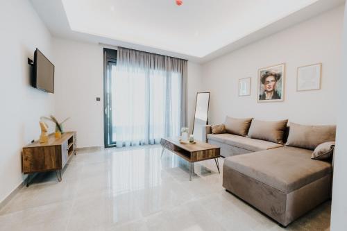 a living room with a couch and a table at Pearl Apartel in Volos