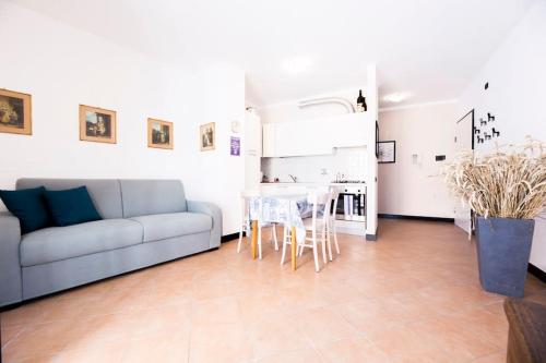 a living room with a couch and a table at Prione's Apartment in Genova