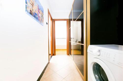 a laundry room with a washer and dryer at Prione's Apartment in Genova