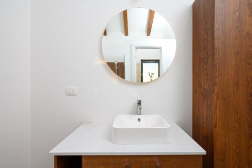 a bathroom with a white sink and a mirror at Villa Linnelle seaview- Rovinj, heated pool in Burići