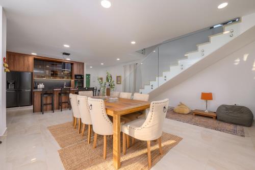 a kitchen and dining room with a wooden table and chairs at Villa Linnelle seaview- Rovinj, heated pool in Burići