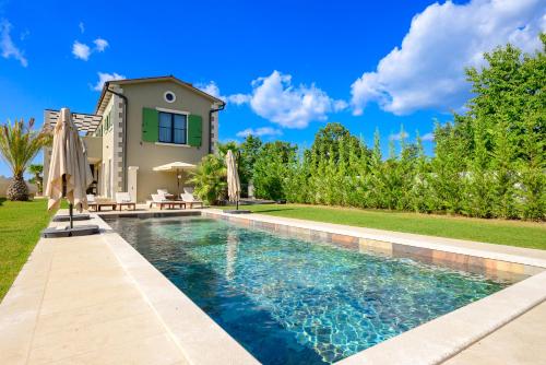 a swimming pool in front of a house at Villa Linnelle seaview- Rovinj, heated pool in Burići