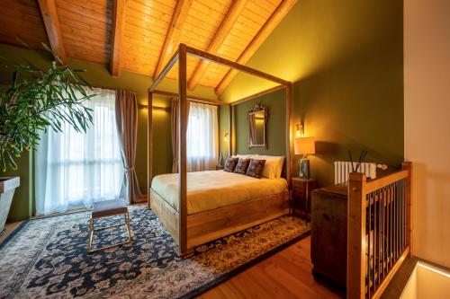 a bedroom with a canopy bed and a chair at La Lupa La Morra in La Morra