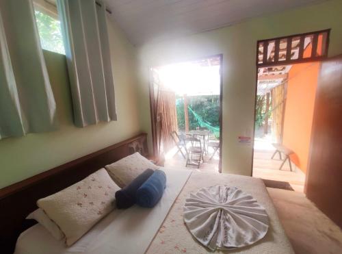 a bedroom with a bed with a bowl on it at Portal do Sabiá Maresias in Maresias